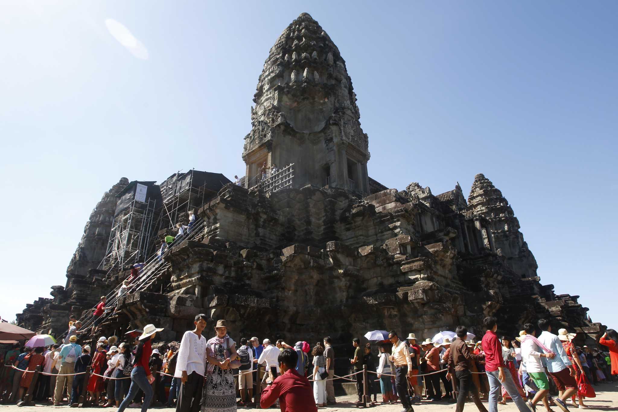 Fierce storm topples tree at Cambodian Angkor temple complex, killing 1 and damaging statues