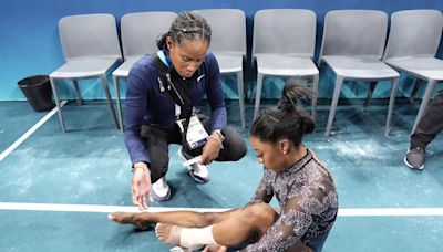 Simone Biles shakes off a calf injury to dominate during Olympic gymnastics qualifying