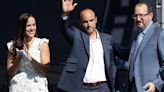 In this photo from October 03, 2021, former Los Angeles Galaxy player Landon Donovan waives as his twin sister Tristan Standling and AEG president Dan Beckerman look on during a ceremony to unveil a statue of...