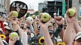 People hold up guavas as they take part in a protest ahead of the inauguration ceremony of Taiwan's president-elect Lai Ching-te