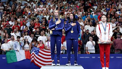 Swimmer Torri Huske asks Gretchen Walsh to join her atop podium in a sweet moment after winning gold