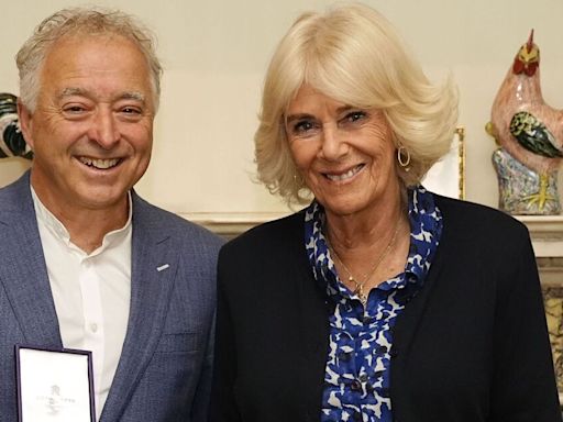 Queen Camilla wows in blue dress as she meets famous author at Clarence House