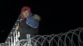 Marble and slingshot-wielding migrants storm EU border fences with ladders