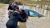 Pictured: Driver trapped by rising flood rescued by passing couple