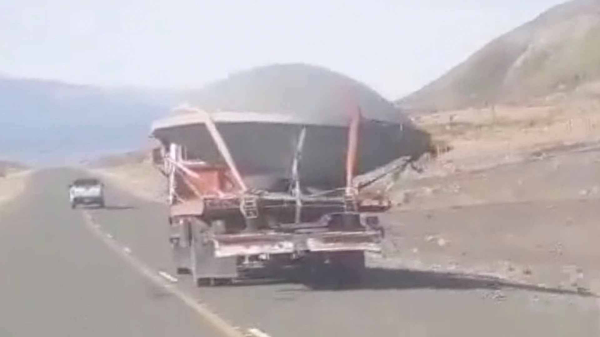 Bizarre photos show huge saucer-shaped 'UFO' being hauled down road by a tractor