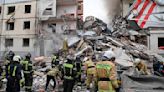 Apartment building partially collapses in a Russian border city after shelling. At least 13 killed