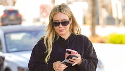 Hilary Duff's STILL pregnant with baby No 4: Actress emerges with big bump after desperately trying natural remedies to bring on labor and banning fans from asking about birth