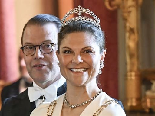 Crown Princess Victoria of Sweden is the image of glamour in a flowing white gown - as her father King Carl Gustaf hosts gala dinner for Finnish President and his wife