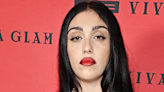 Madonna’s Daughter Lourdes Strikes a Pose in Form-Fitting Leopard Print Dress and Bold Red Lip at Event