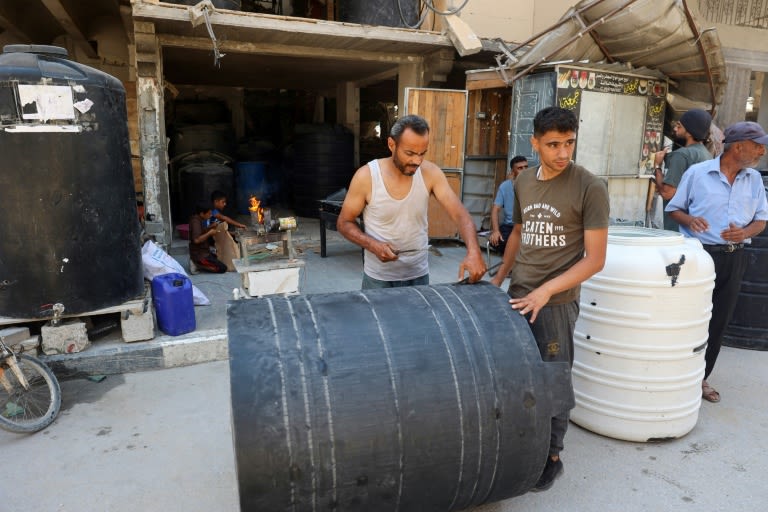 Gaza workshop repairs water tanks hit by bullets, bombs