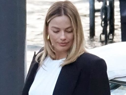 Margot Robbie flashes midriff in cropped white top