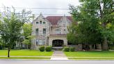 Urbana mansion for sale, complete with carved lion's heads, stained glass and turret