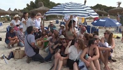 Mallorca locals cram together under one parasol in latest overtourism protest