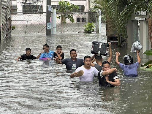 Taiwan prepares for a strong typhoon that worsened monsoon rains in the Philippines, killing 13