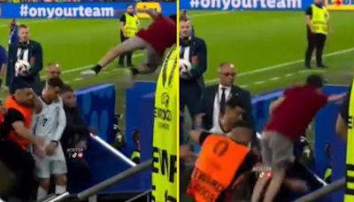 Cristiano Ronaldo narrowly avoids being two-footed by fan jumping from stands