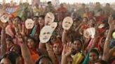 ...Bharatiya Janata Party (BJP) cheer as they attend India's Prime Minister Narendra Modi's election campaign rally on May 21. Exit polls show 73-year-old Modi...