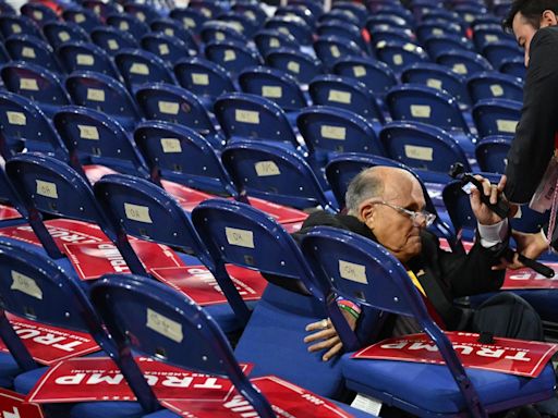 Rudy Giuliani takes a fall and tumbles into chairs while walking RNC floor