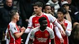 Arsenal survive Spurs fightback to boost title charge