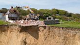Farmhouse left teetering over cliff edge flattened after owner forced to flee