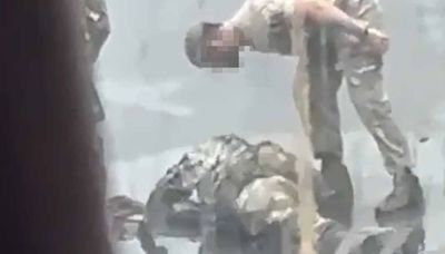 Army instructor forces junior soldier to lie in a puddle