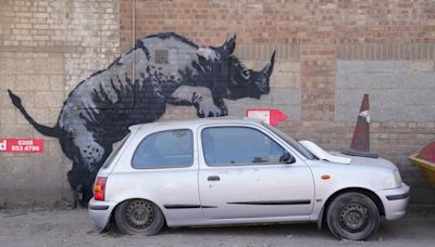 Banksy’s rhino artwork defaced by man in balaclava hours after being unveiled