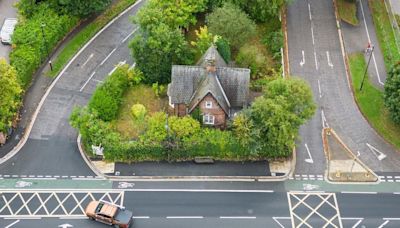 Lonely house sits slap bang in the middle of a traffic island - why is it there?