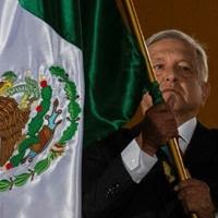 Mexican President Andres Manuel Lopez Obrador waves the national flag during Independence Day celebrations
