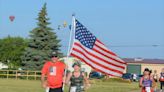 Flag-carrying couple run Battle Creek Half Marathon in the memory of fallen Marine
