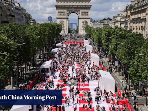 Paris’ Champs-Elysees turned into a mass picnic blanket for an unusual meal