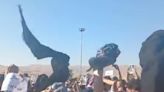 Women in Iran defy the Islamic regime by removing their headscarves and waving them in the air in protests over police custody death, video shows