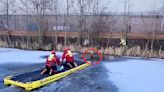 Moment dog is rescued after falling into icy canal while chasing ducks