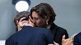 Macron causes a stir receiving a impassioned kiss from his minister