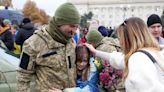 Video: Kherson resident unearths Ukrainian flag she buried under paving stones as city celebrates liberation