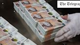 Britain’s banknote printer in break-up talks as it delays results