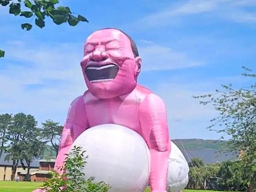 Giant inflatable squatting man which can be seen for miles appears in Welsh town