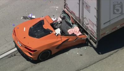 Driver hospitalized after sports car smashes into back of semi-truck