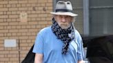 Sir Ian McKellen hides neck brace with a scarf after falling off west end stage