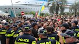 A cruise ship carrying Russian passengers was greeted with jeers and heckles in Georgia and was forced to leave the port early