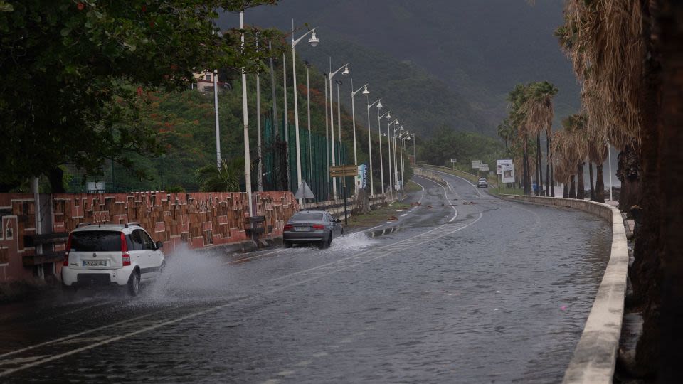 Tropical Storm Ernesto nears hurricane strength as it skirts Puerto Rico, bringing concerns of floods and power outages