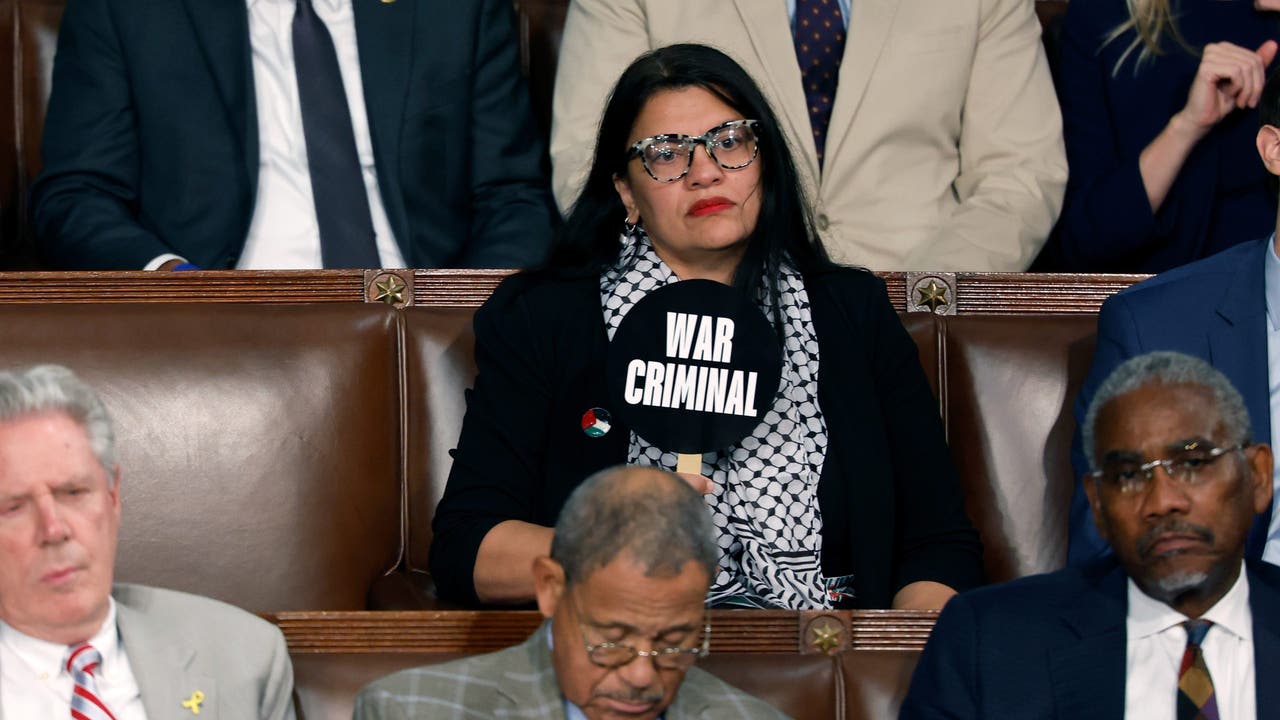 Rashida Tlaib holds sign calling Netanyahu a 'war criminal' during speech to Congress