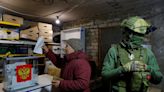 Putin’s party hit by cyberattack as armed Russian troops oversee voters in occupied Ukraine