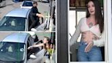 Bikini-clad barista takes hammer to customer's windshield after he throws coffee at her