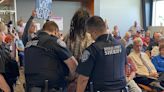 Frequent public commenter arrested at Douglas County Commission meeting after holding obscene signs insulting commissioner