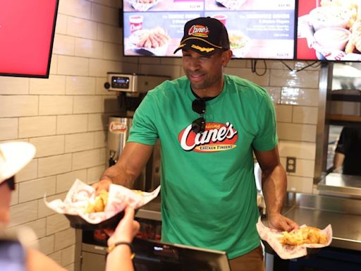 Boston Celtics center Al Horford serves food to fans at Raising Cane's