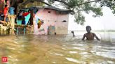 Two men, in flood-ravaged Lakhimpur Kheri, walk home with their sister's body