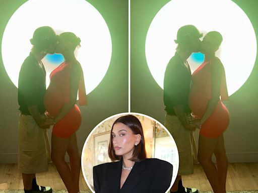 Justin Bieber kisses wife Hailey as she cradles baby bump in a tight red dress