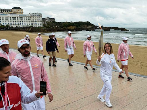 Man is held in France over posts about California murders as Olympic torch passes through Bordeaux