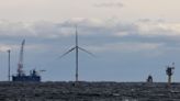 Decades after Europe, turning blades send first commercial offshore wind power onto US grid