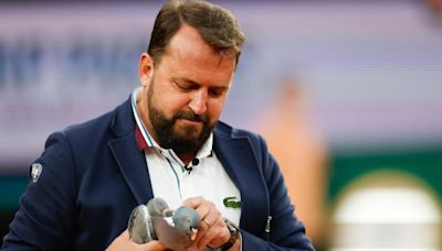 On a wing and a prayer, a pigeon is rescued by a French Open chair umpire during a match