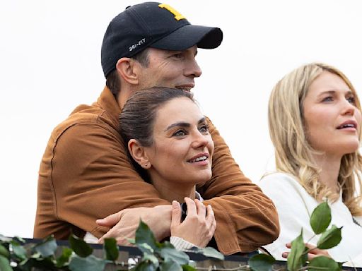 Ashton Kutcher and Mila Kunis pack on the PDA at Morgan Wallen gig